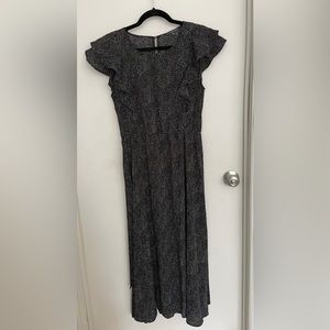 Black and white flowy midi dress with high neck.